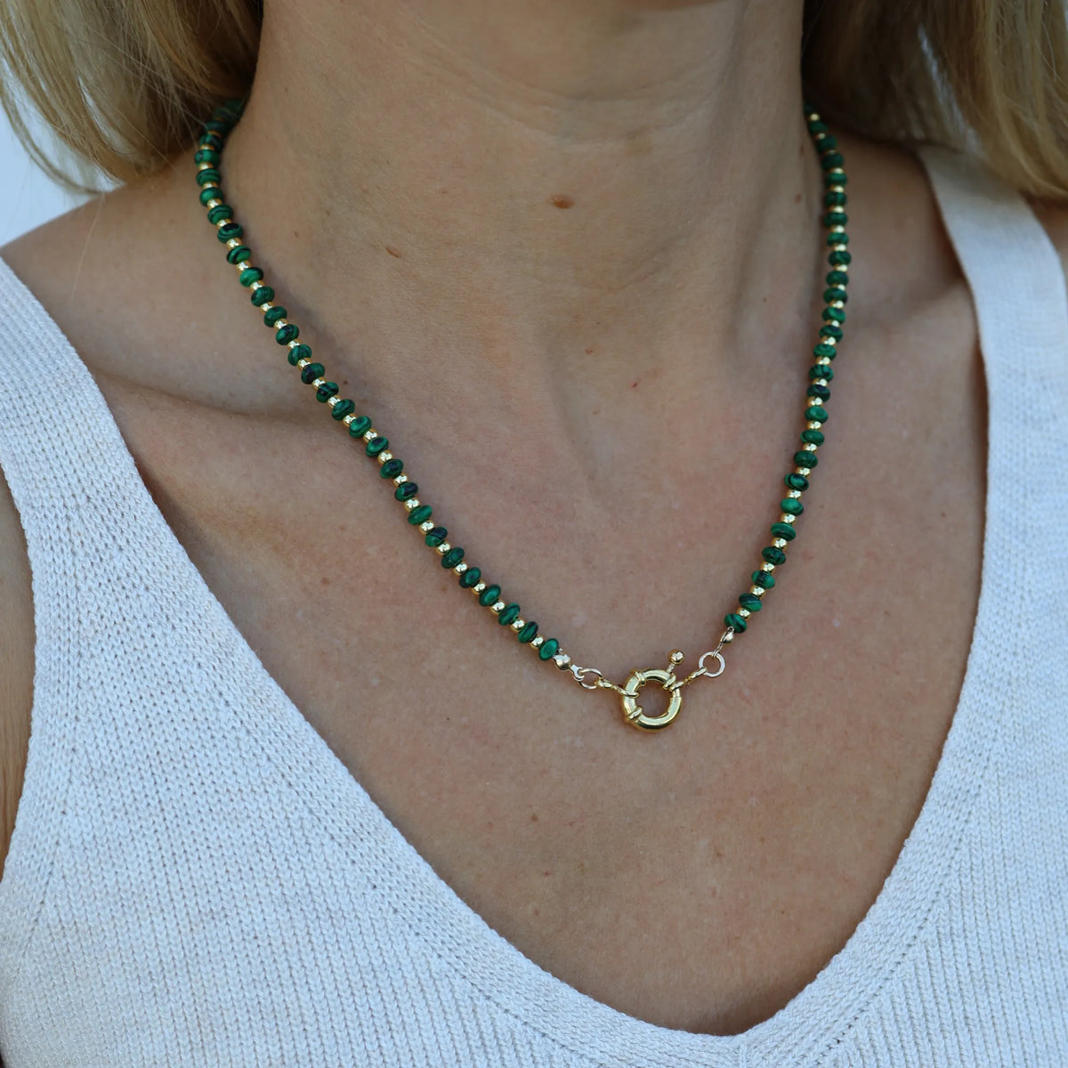 Woman wearing the Malachite Muse necklace by Mama Bijoux x Isla Sol crafted with natural malachite gemstone beads and 18k gold accent beads.