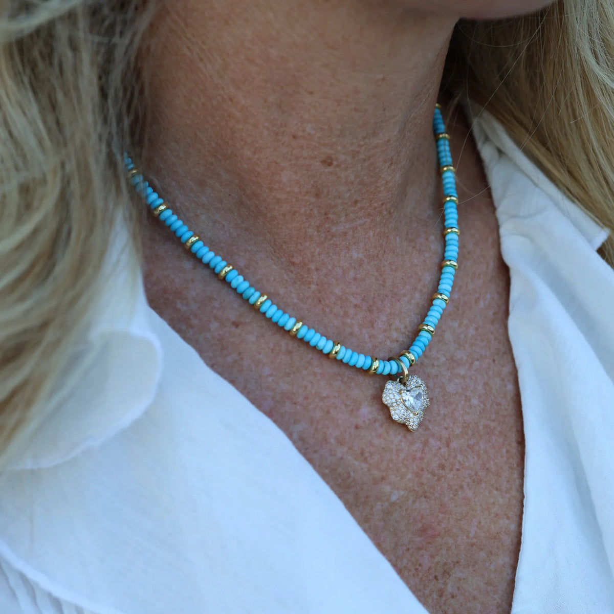 Woman wearing the Turquoise and Gold Beaded Necklace by Mama Bijoux x Isla Sol crafted with natural turquoise gemstone beads and gold filled accents.