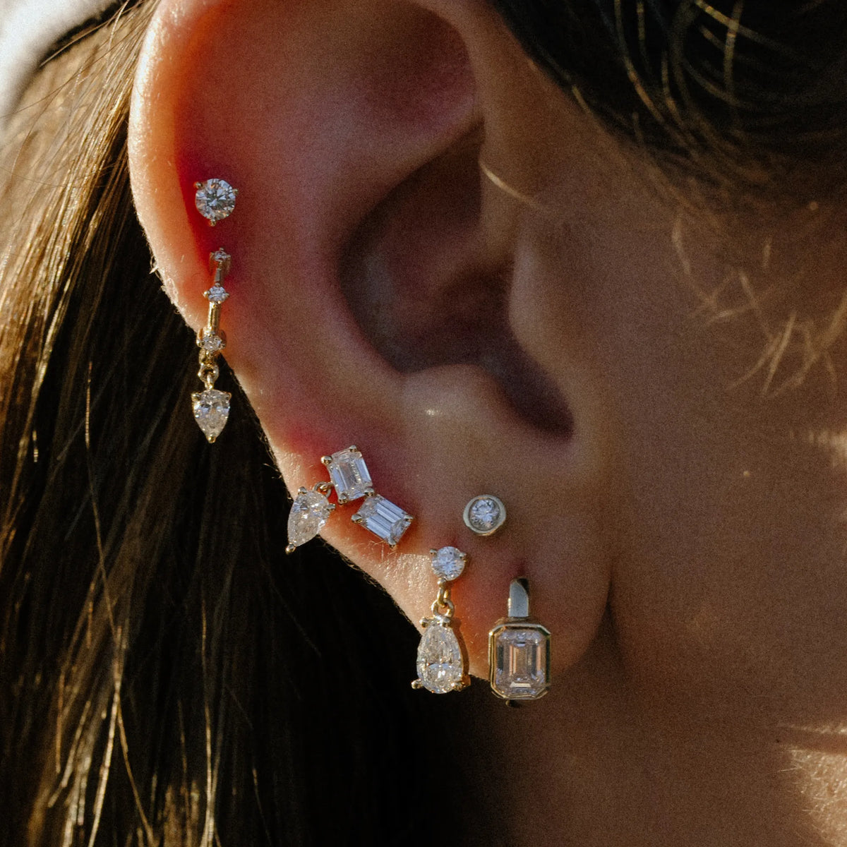 Pear lab diamond dangle stud earring worn in ear stack with huggies and studs, gold dangle earrings by Mama Bijoux Orange County