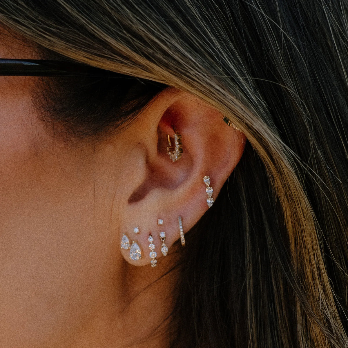 Pear duo lab diamond stud earrings worn in ear stack with huggies and hoops, everyday diamond stud earrings by Mama Bijoux Orange County