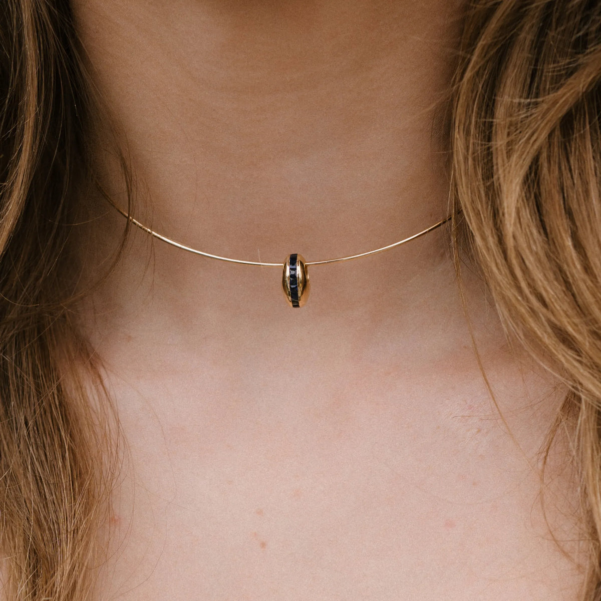 14k yellow gold necklace with channel set sapphire puffy bead charm worn close up, dainty necklace by Mama Bijoux Costa Mesa