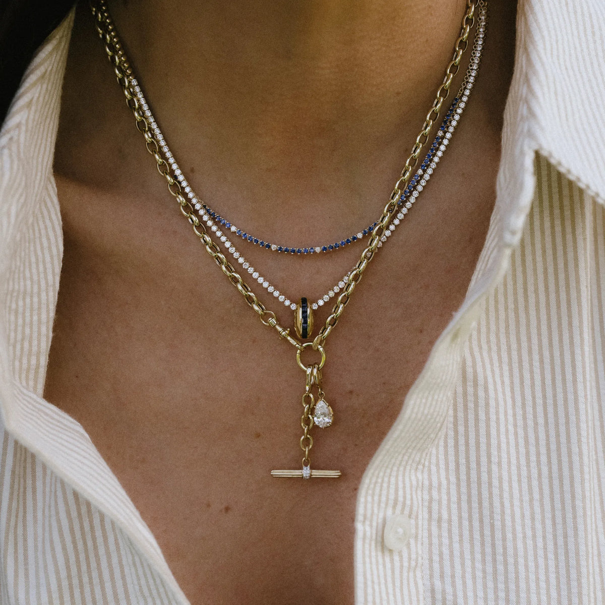 Blue sapphire and diamond half tennis necklace layered with pendant necklaces, layered necklace styling by Mama Bijoux Orange County