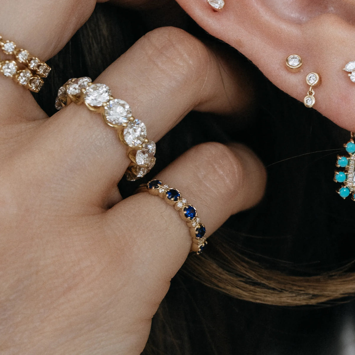September birthstone sapphire and diamond stacking pinky ring in curated ring stack with diamond eternity band and diamond earrings 14k yellow gold Mama Bijoux Costa Mesa