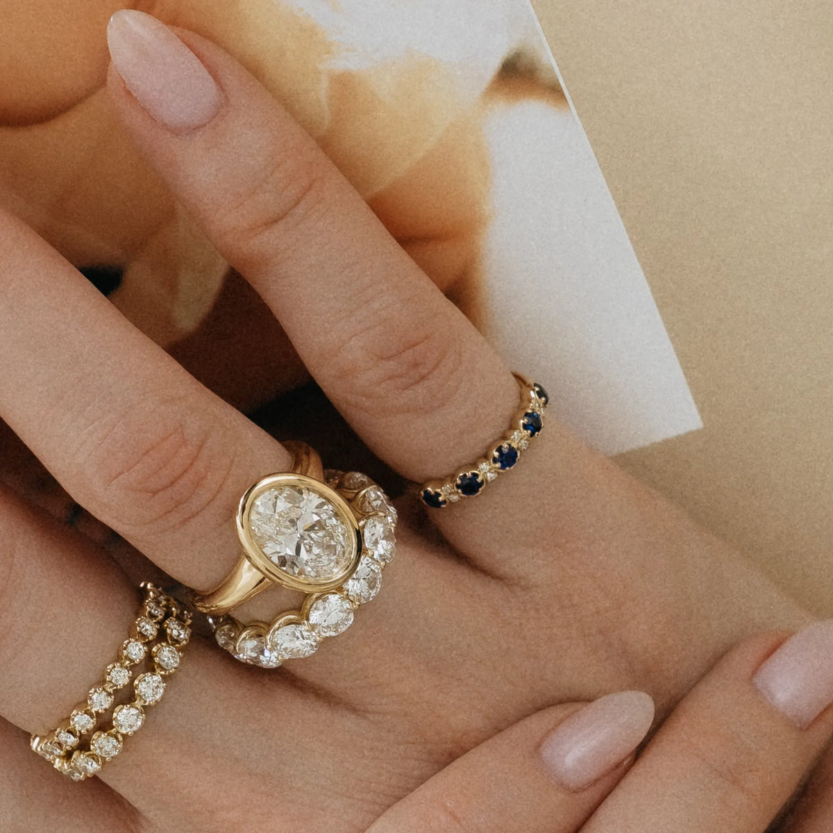 September birthstone sapphire and diamond stacking pinky ring worn with oval diamond bezel engagement ring and diamond bands 14k yellow gold Mama Bijoux Costa Mesa