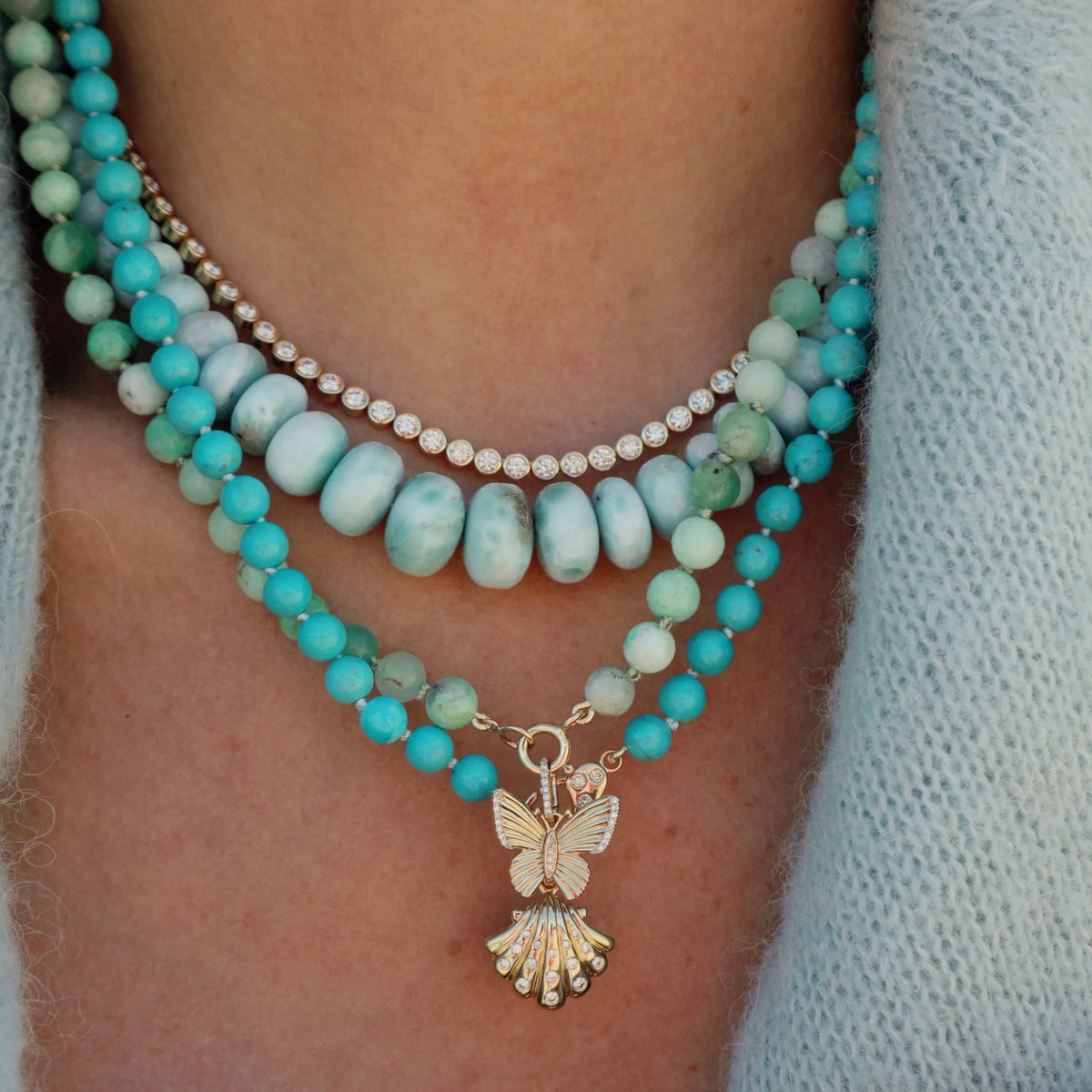 Close-up of Sleeping Beauty turquoise beads on a luxury beaded necklace, showcasing the stone's distinctive blue color