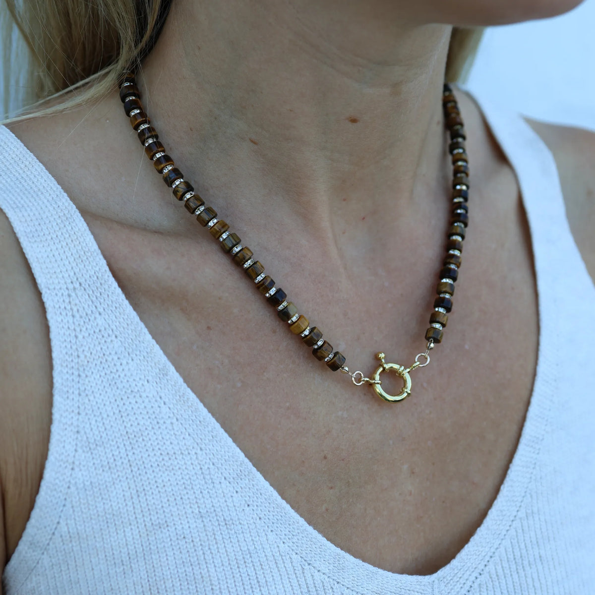 Close-up of the Driftwood Glow necklace by Mama Bijoux x Isla Sol crafted with natural tiger's eye gemstone beads and sparkling rhinestone accents.